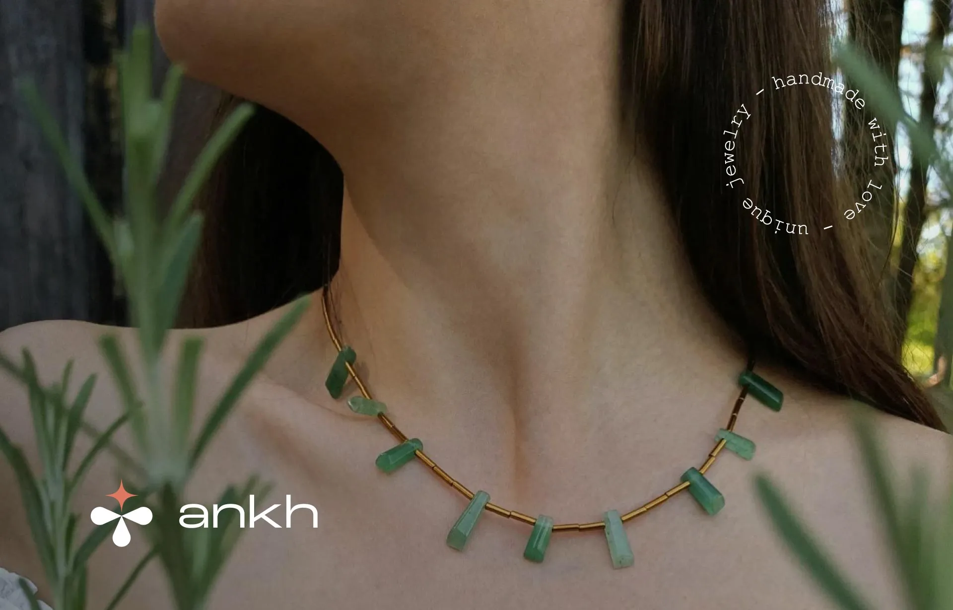 Ankh hand made jewelry on a person with logo on visual